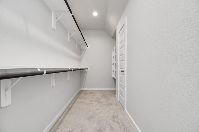 spacious closet featuring light carpet