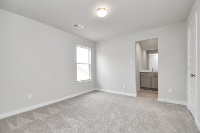 unfurnished room with light carpet