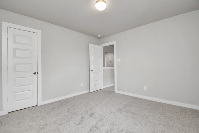 unfurnished room featuring light colored carpet