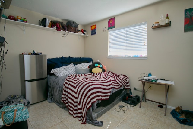 tiled bedroom with stainless steel refrigerator