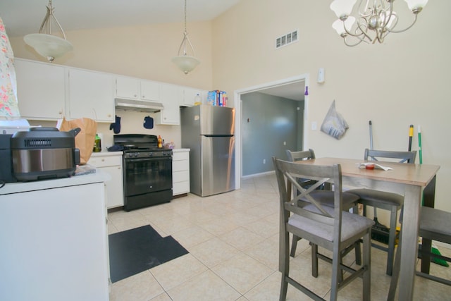 kitchen with stainless steel refrigerator, white cabinetry, decorative light fixtures, and black gas range oven