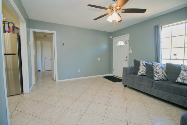 tiled living room featuring ceiling fan