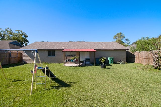 back of property featuring a patio area and a lawn