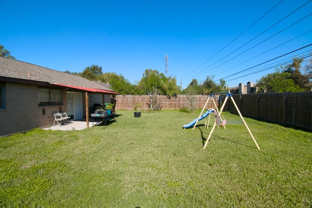 view of yard featuring a playground and a patio area