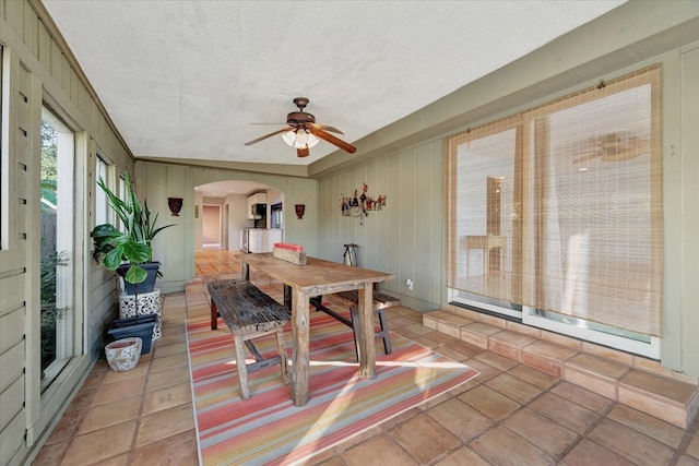 dining area featuring ceiling fan, ornamental molding, and a textured ceiling