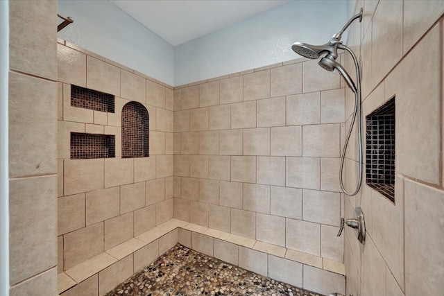 bathroom with tiled shower