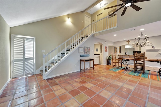 living room with tile patterned floors, ceiling fan with notable chandelier, and high vaulted ceiling