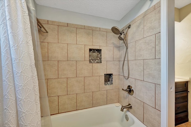 bathroom with shower / bath combo and a textured ceiling