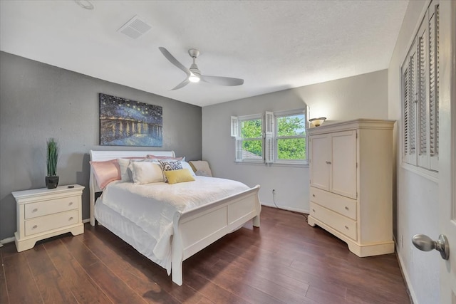 bedroom featuring ceiling fan and dark hardwood / wood-style floors