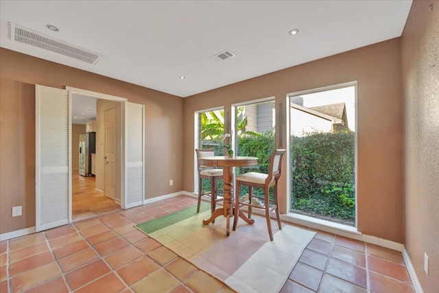 dining space featuring light tile patterned floors