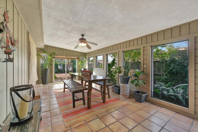 unfurnished sunroom featuring plenty of natural light and ceiling fan