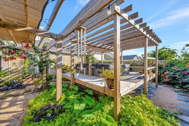 wooden terrace featuring a pergola and a hot tub