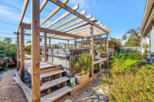 wooden deck with a pergola and a hot tub