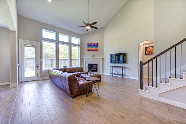 living room featuring ceiling fan and a high ceiling