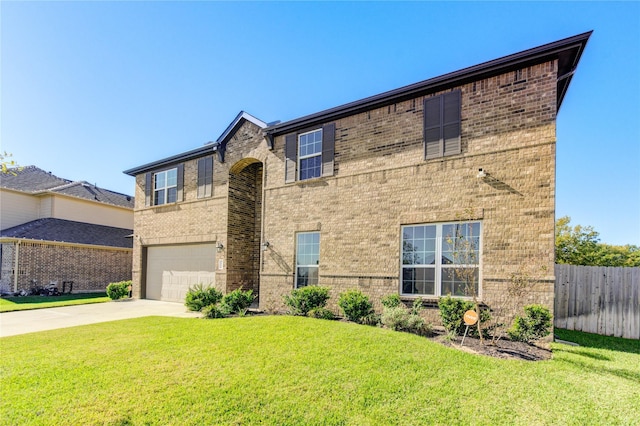 view of front of property featuring a front yard and a garage