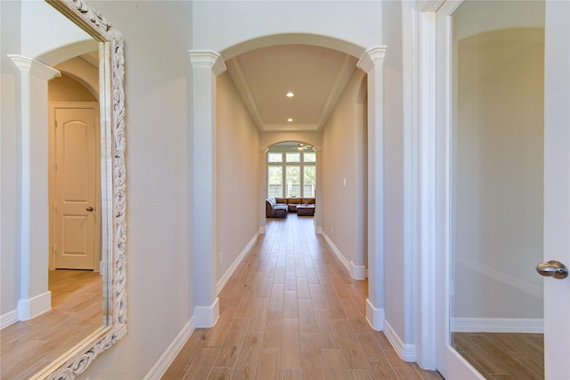 hall featuring ornate columns and light hardwood / wood-style flooring