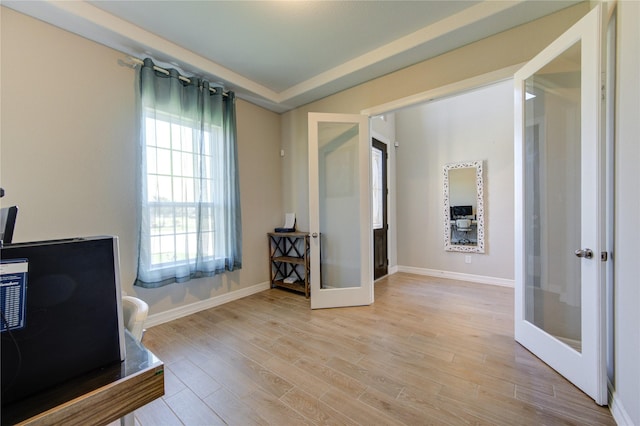 home office with french doors and light wood-type flooring