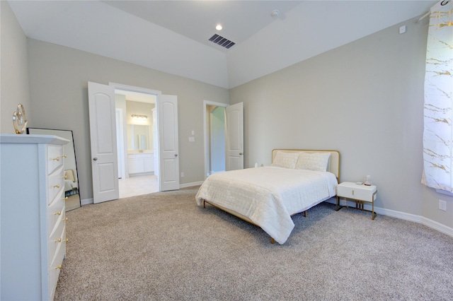 carpeted bedroom featuring connected bathroom and lofted ceiling