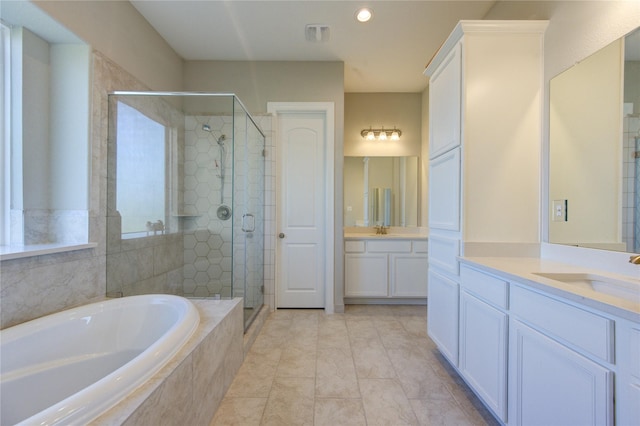 bathroom with tile patterned floors, plus walk in shower, and vanity