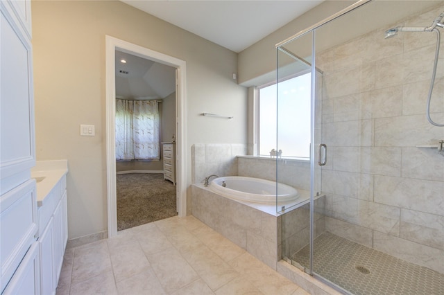 bathroom with tile patterned floors, vanity, and plus walk in shower