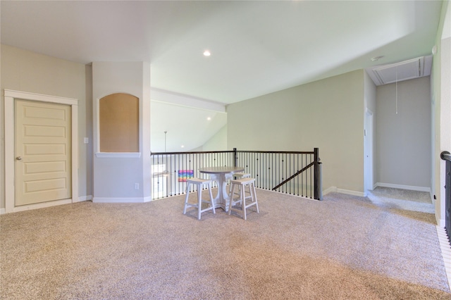 interior space with light colored carpet and vaulted ceiling