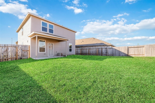 back of house with a lawn and a patio area