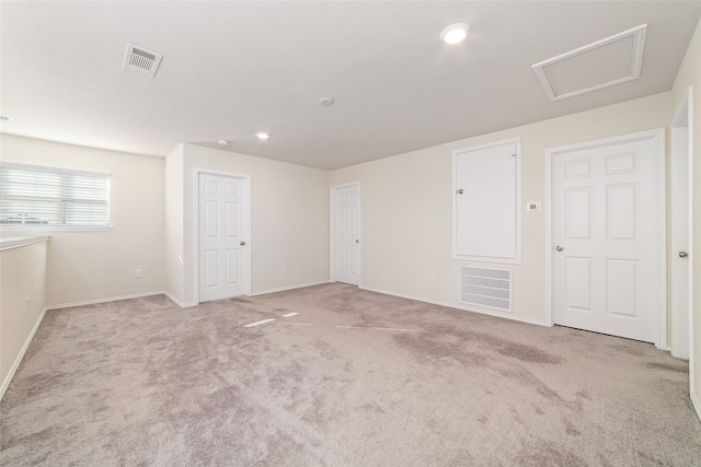 empty room featuring light carpet