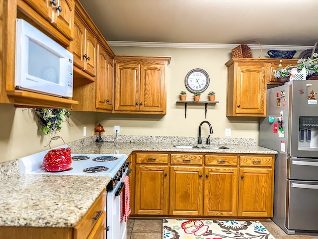 kitchen featuring white appliances, ornamental molding, and sink