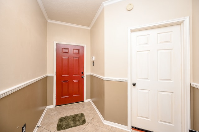 tiled foyer featuring crown molding and a textured ceiling