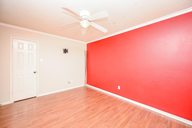 empty room with hardwood / wood-style flooring, ceiling fan, crown molding, and a textured ceiling