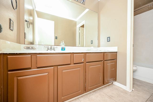 bathroom with tile patterned flooring, vanity, and toilet