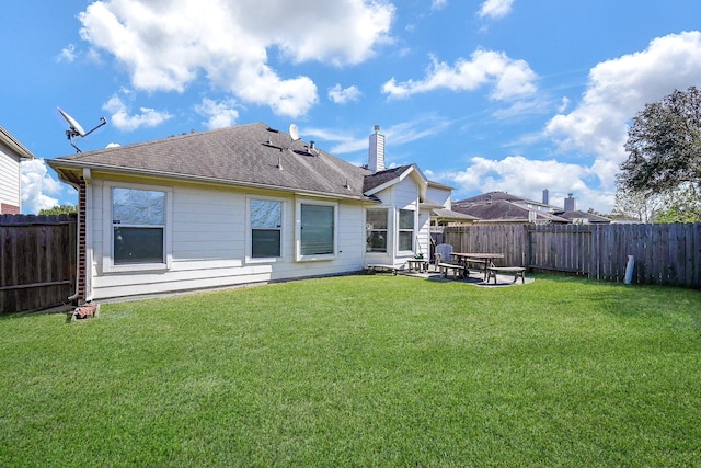 rear view of property with a lawn and a patio area