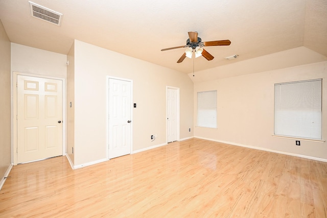 empty room with vaulted ceiling, light hardwood / wood-style flooring, and ceiling fan