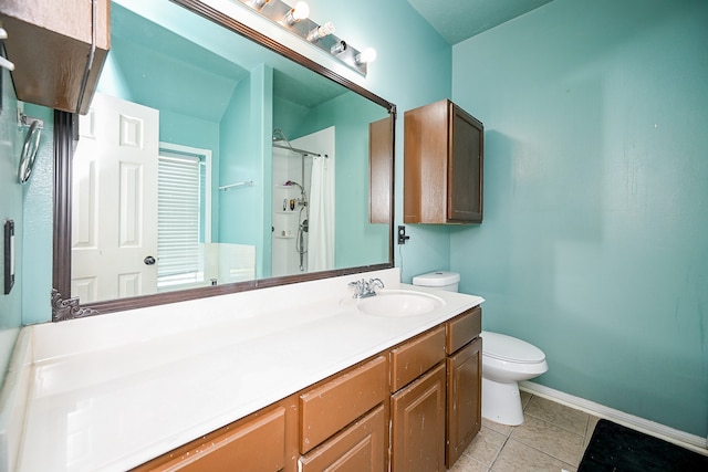 bathroom featuring toilet, vanity, tile patterned floors, and walk in shower