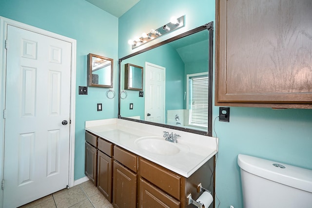 bathroom featuring tile patterned flooring, vanity, and toilet