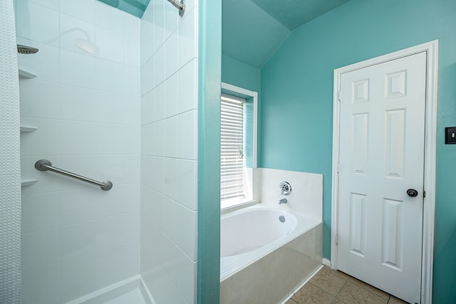 bathroom with tile patterned flooring, shower with separate bathtub, and vaulted ceiling