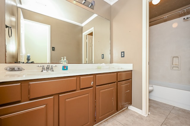 bathroom featuring tile patterned floors, vanity, toilet, and crown molding