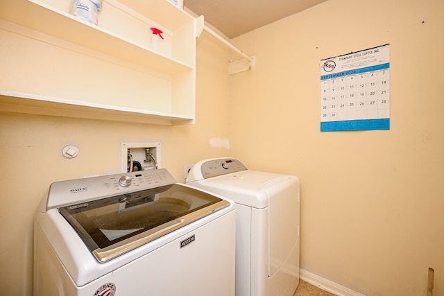 clothes washing area with washing machine and clothes dryer