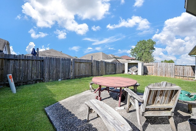 view of yard with a storage shed and a patio