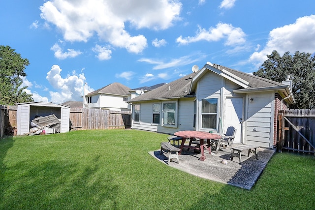 back of house with a yard and a patio