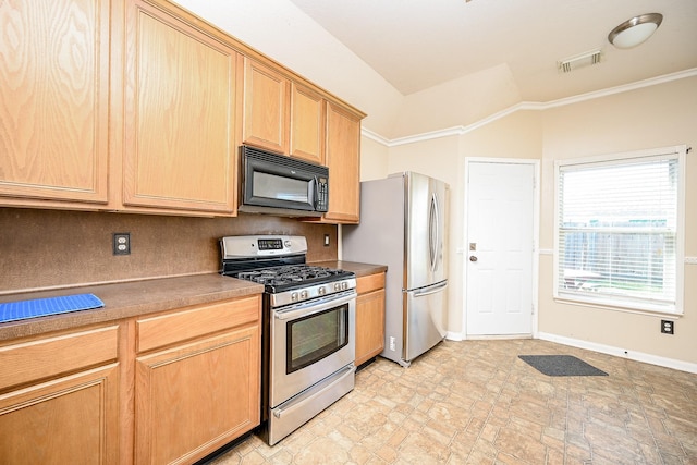 kitchen with stainless steel appliances, vaulted ceiling, and ornamental molding