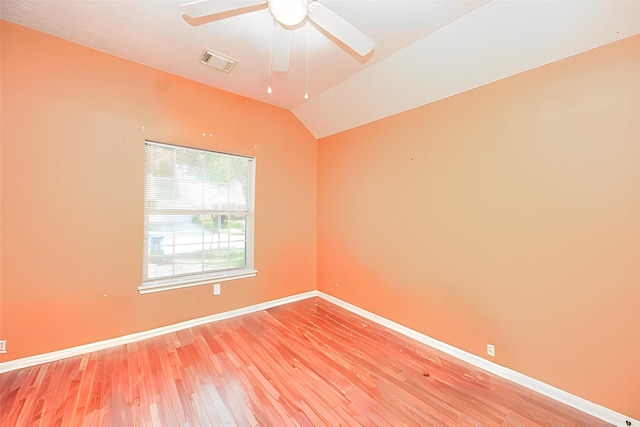 spare room featuring hardwood / wood-style floors, ceiling fan, and vaulted ceiling