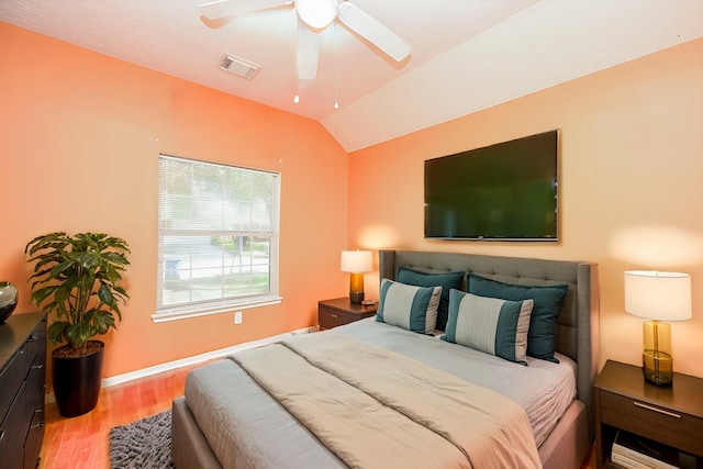 bedroom with ceiling fan, hardwood / wood-style floors, and lofted ceiling