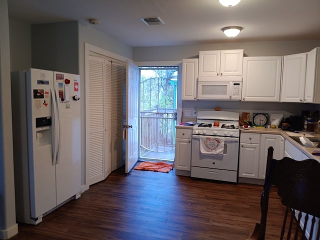 kitchen with white cabinetry, dark hardwood / wood-style floors, and white appliances