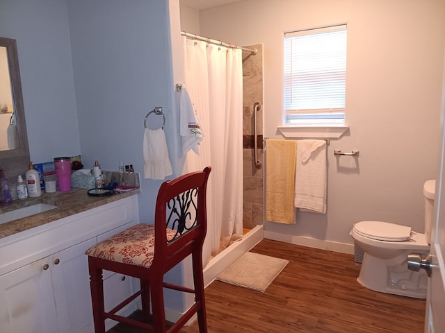 bathroom featuring wood-type flooring, toilet, walk in shower, and sink