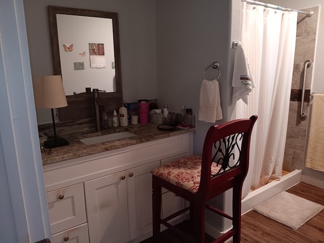 bathroom with hardwood / wood-style flooring, vanity, and a shower with shower curtain