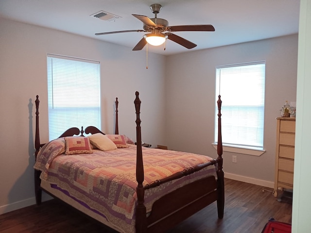 bedroom with ceiling fan and dark wood-type flooring