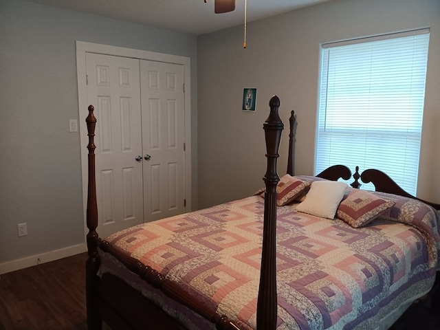 bedroom with dark hardwood / wood-style floors, a closet, and ceiling fan