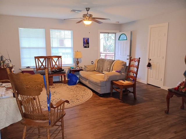 living room featuring plenty of natural light, ceiling fan, and dark hardwood / wood-style flooring