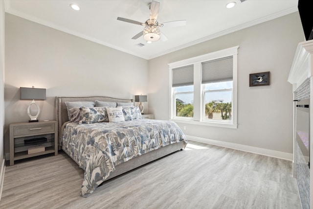 bedroom featuring ceiling fan, light hardwood / wood-style flooring, and crown molding